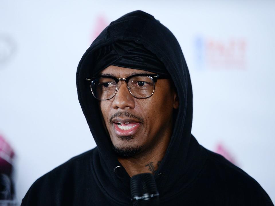 Nick Cannon wearing a black hoodie on the red carpet