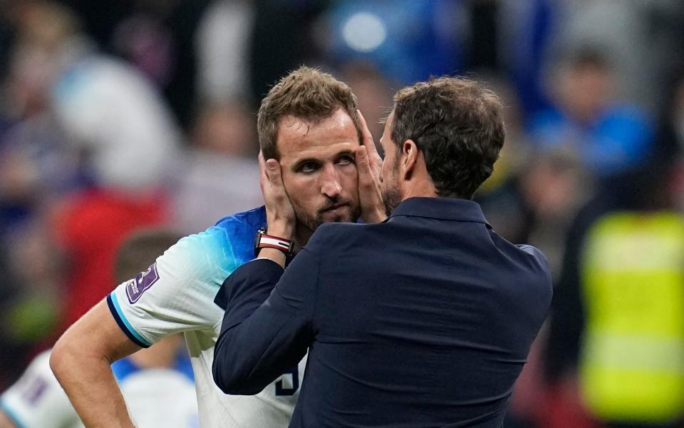 England's Harry Kane is comforted by head coach Gareth Southgate after losing 1-2 against France - AP