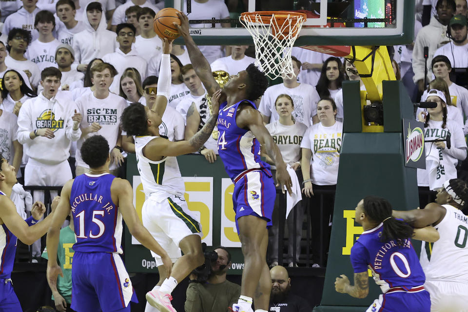 Baylor guard Keyonte George, center left, has his shot blocked by Kansas forward K.J. Adams Jr., center right, during the first half of an NCAA college basketball game Monday, Jan. 23, 2023, in Waco, Texas. (AP Photo/Jerry Larson)