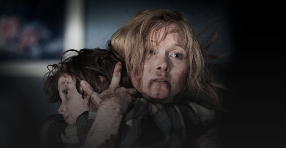 Bloody mother holds son in a still from The Babadook.