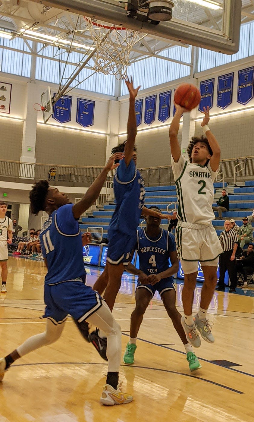 Oakmmont's J.J. Hicks goes up for two points in front of Worcester Tech's Worla Dra Zonyrah (11), Teriq Goodman (23) and Charles Manu (4) during the Central Mass. Class B championship game, Friday afternoon, at Worcester State University.
