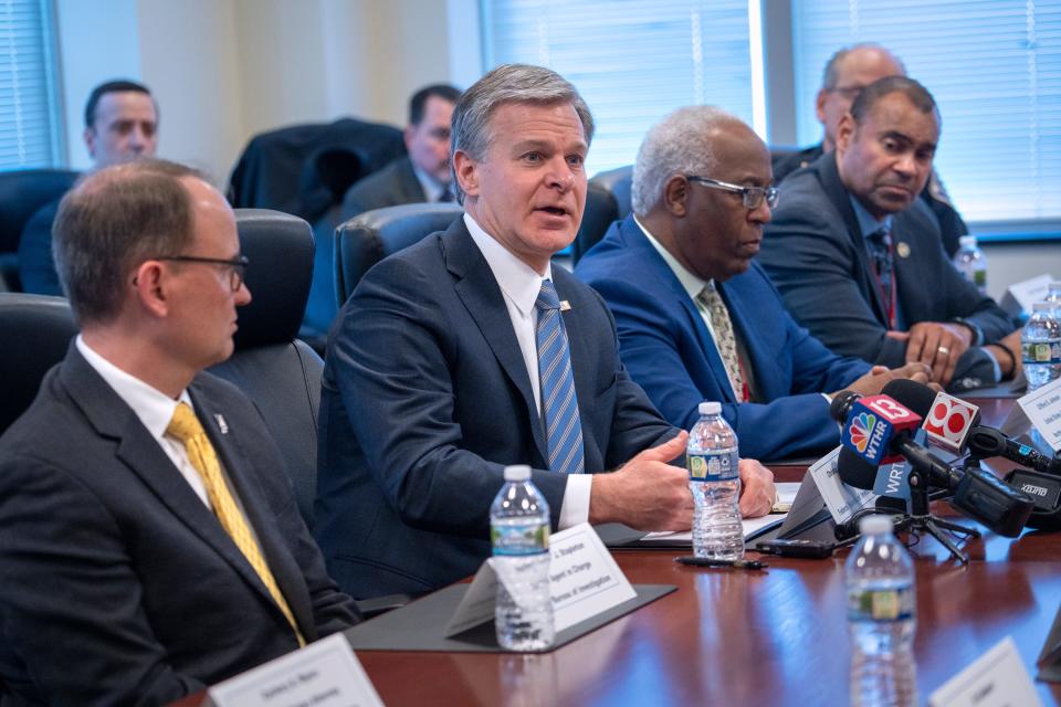 Christopher Wray, center, director of the FBI, speaks to the press before the U.S. Attorney’s Office and Law Enforcement Partners meeting Thursday, March 30, 2023 in the FBI Indiana Headquarters.