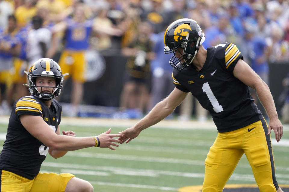 Iowa place kicker Aaron Blom (1) reacts with holder Tory Taylor, left, after missing a field goal during the first half of an NCAA college football game, Saturday, Sept. 3, 2022, in Iowa City, Iowa. (AP Photo/Charlie Neibergall)