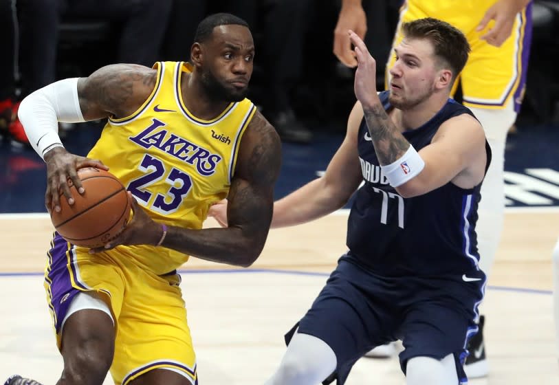 DALLAS, TEXAS - NOVEMBER 01: LeBron James #23 of the Los Angeles Lakers dribbles the ball against Luka Doncic #77 of the Dallas Mavericks in the first quarter at American Airlines Center on November 01, 2019 in Dallas, Texas. NOTE TO USER: User expressly acknowledges and agrees that, by downloading and or using this photograph, User is consenting to the terms and conditions of the Getty Images License Agreement. (Photo by Ronald Martinez/Getty Images)