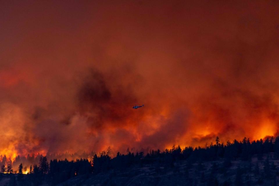 PHOTO: A helicopter battles the McDougall Creek wildfire as it burns in the hills West Kelowna, British Columbia, Canada, Aug. 17, 2023. (Darren Hull/AFP via Getty Images)