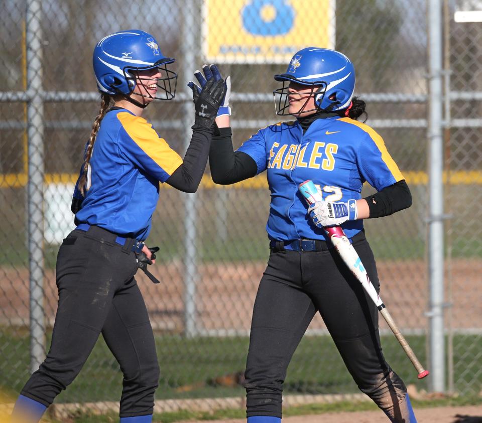 Irondequoit's Marlayna Cartagena, right, celebrates after scoring a run with teammate Amanda Northup, left, during their game against Webster Thomas Wednesday, April 24, 2019 in Webster.