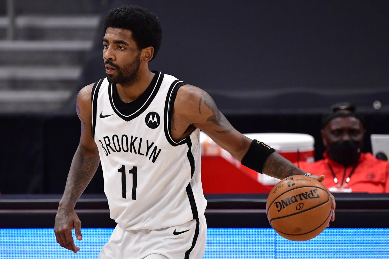 Kyrie Irving #11 of the Brooklyn Nets dribbles the ball during the third quarter against the Toronto Raptors at Amalie Arena on April 21, 2021 in Tampa, Florida. NOTE TO USER: User expressly acknowledges and agrees that, by downloading and or using this photograph, User is consenting to the terms and conditions of the Getty Images License Agreement. (Photo by Douglas P. DeFelice/Getty Images)