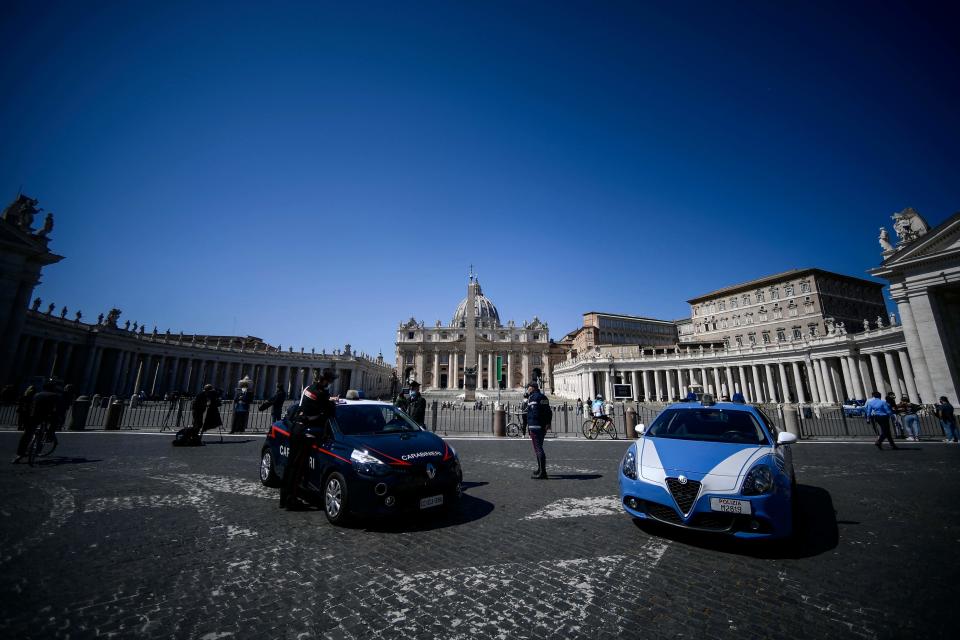 Italian Carabinieri Police and Italian State Police stand guard on April 04, 2021, by a barrier preventing access to St. Peter's Square in the Vatican after the Pope's Easter Mass.