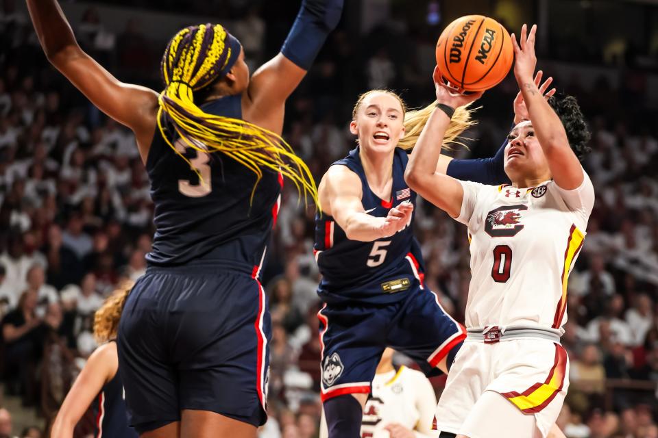 Feb 11, 2024; Columbia, South Carolina, USA; South Carolina Gamecocks guard Te-Hina Paopao (0) shoots over UConn Huskies forward Aaliyah Edwards (3) and guard Paige Bueckers (5) in the first half at Colonial Life Arena. Mandatory Credit: Jeff Blake-USA TODAY Sports