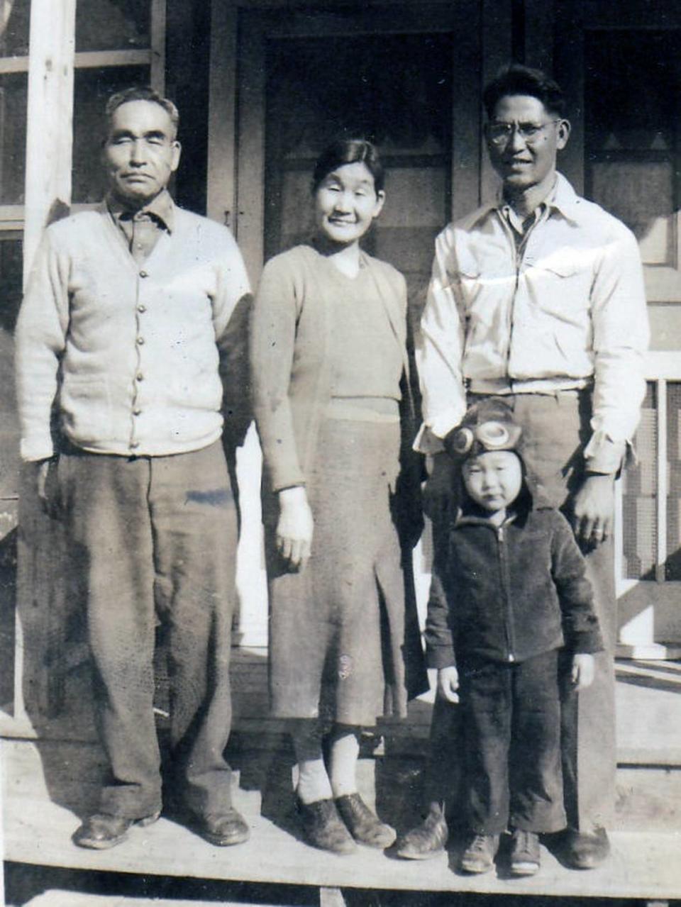 Tameji Eto gives his blessing to his son-in-law, Leo Kikuchi, and his son, Ronnie, at a high security relocation camp in Louisiana, February 1944.