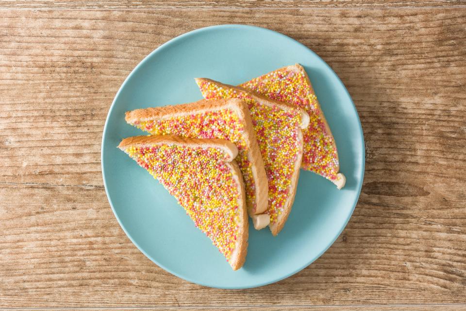 So what exactly is fairy bread? Well, here’s the big reveal: it’s white bread sliced into triangles, spread with butter and topped with rainbow sprinkles. That’s it.