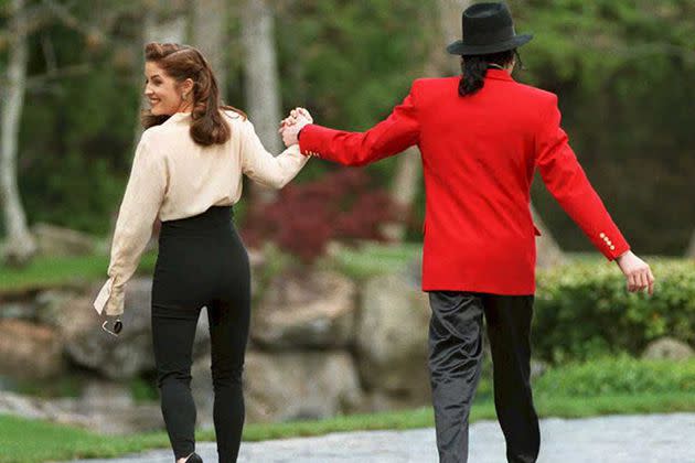 <p>This content is subject to copyright.</p> Lisa-Marie Presley and Michael Jackson walking in Neverland Ranch