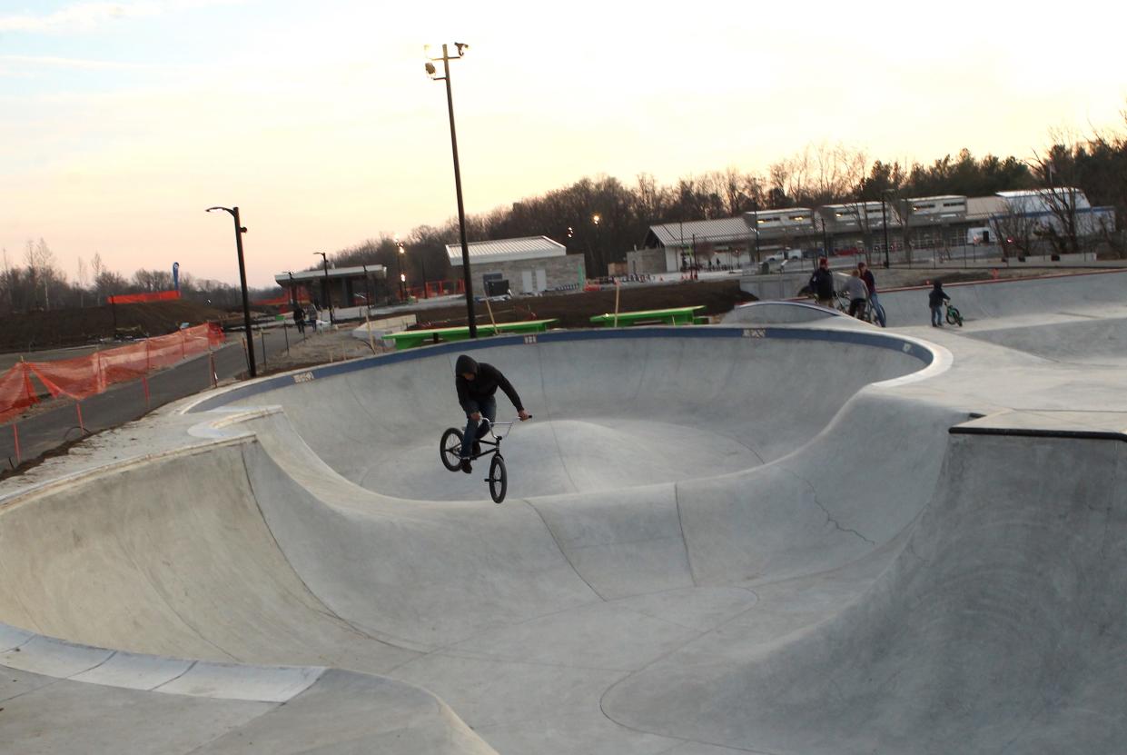 A bike rider does tricks at the skatepark in Switchyard Park in Bloomington in November 2019. Hunger Skateparks designed and built the facility.