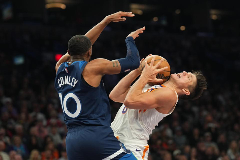 Minnesota Timberwolves guard Mike Conley (10) fouls Phoenix Suns guard Grayson Allen (8) during the second half at Footprint Center.