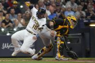Milwaukee Brewers' Omar Narvaez slides safely past Pittsburgh Pirates catcher Michael Perez during the second inning of a baseball game Friday, June 11, 2021, in Milwaukee. Narvaez scored from second on a hit by Jackie Bradley Jr.. (AP Photo/Morry Gash)