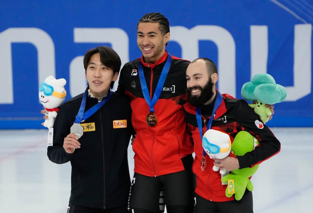 From left to right, silver medallist Park Ji-won of South Korea, gold medallist William Dandjinou of Canada, and bronze medalist Steven Dubois, also of Canada, pose during the award ceremony for the men's 1,500-metre final n Seoul, South Korea, on Sunday. (Ahn Young-joon/The Associated Press - image credit)