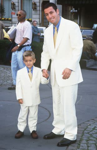 <p>Arnaldo Magnani/Getty</p> A young Adam Sandler and Cole Sprouse