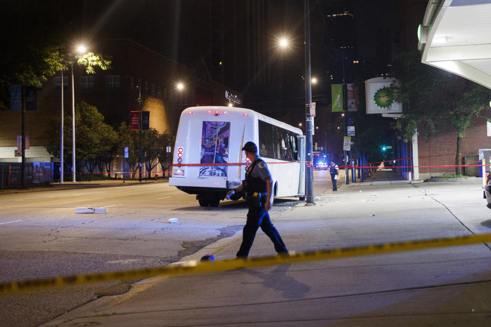 Chicago police officers work at the scene where at least eight people were wounded in a shooting involving a party bus in the 1600 block of North LaSalle Drive in the Old Town Triangle neighborhood Thursday July 22, 2021 in Chicago.(Armando L. Sanchez /Chicago Tribune via AP)