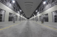 A cell area stands empty during a media tour of The Terrorism Confinement Center in Tecoluca, El Salvador, Thursday, Feb. 2, 2023. The "mega-prison" still under construction has a maximum capacity of 40,000 and is intended to imprison gang members, according to the government. (AP Photo/Salvador Melendez)