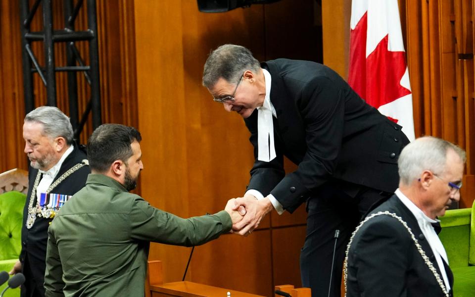Speaker of the House of Commons Anthony Rota shakes hands with Ukrainian President Volodymyr Zelensky. Rota is apologizing for recognizing in Parliament a man who fought for a Nazi military unit during World War II