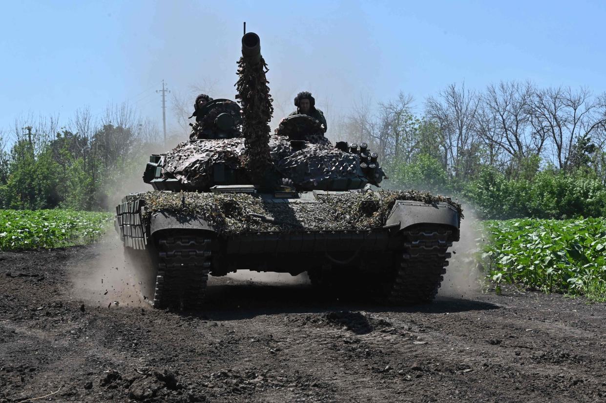 Ukrainian servicemen ride on a tank not far from the front line in the Kharkiv region (AFP via Getty Images)