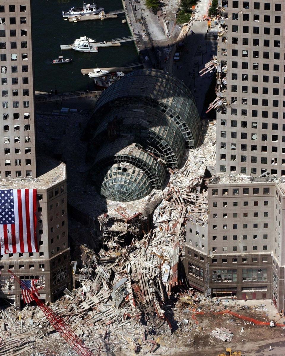 The Winter Garden surrounded by debris. Buildings nearby were heavily damaged by the falling twin towers (AP)