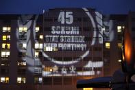 A message to mark the 45th birthday of seven-times former Formula One world champion Michael Schumacher is projected by fans on the facade of the CHU hospital emergency unit in Grenoble, French Alps, where Michael Schumacher is hospitalized January 3, 2014. REUTERS/Charles Platiau