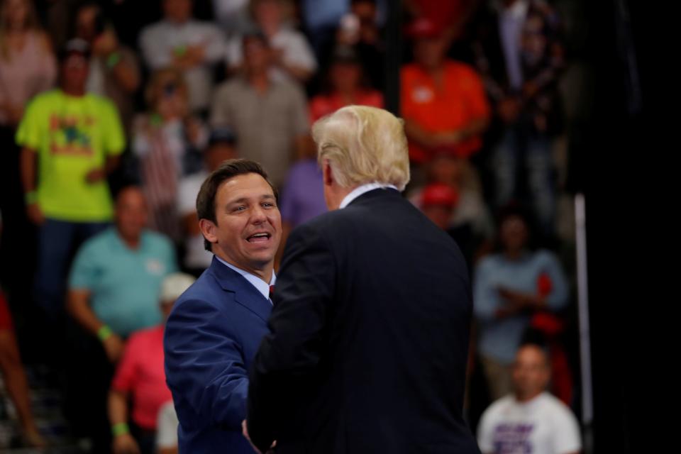 Rep. Ron DeSantis (L) joins President Donald Trump during a campaign rally in Estero, Florida on October 31, 2018.