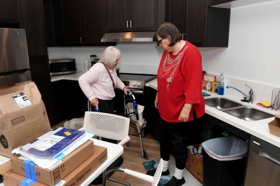 Sandie Moore, 81, and daughter Wendy Rasmussen, 58, stand in the kitchen of Wendy's apartment at the Vintage at Anacapa Canyon senior apartments in Camarillo on April 12. The two women live directly across from each other in the building, but Rasmussen's apartment is fitted for limited mobility, while Moore's is not.