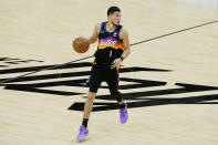 Phoenix Suns guard Devin Booker (1) dribbles against the Los Angeles Clippers during the first half of Game 2 of the NBA basketball Western Conference Finals, Tuesday, June 22, 2021, in Phoenix. (AP Photo/Matt York)