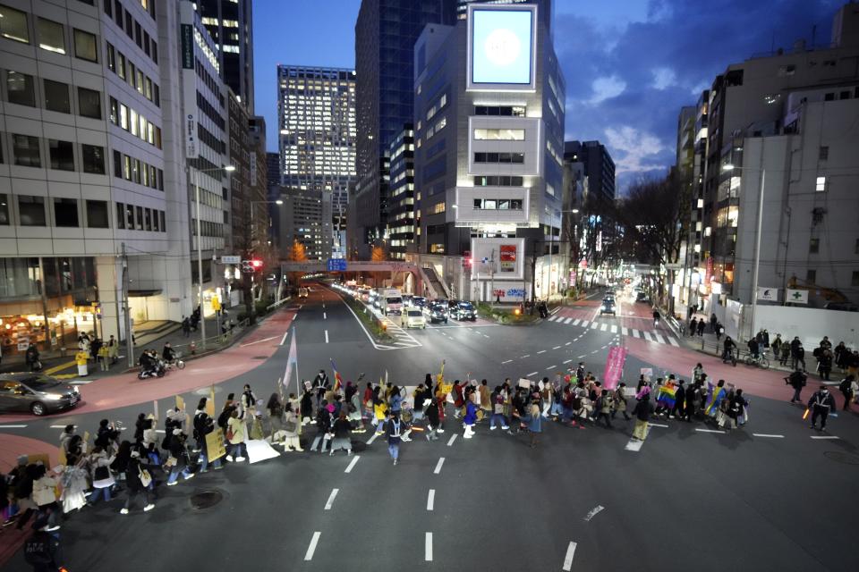 Participants march to mark the International Women's Day Friday, March 8, 2024, in Tokyo. (AP Photo/Eugene Hoshiko)