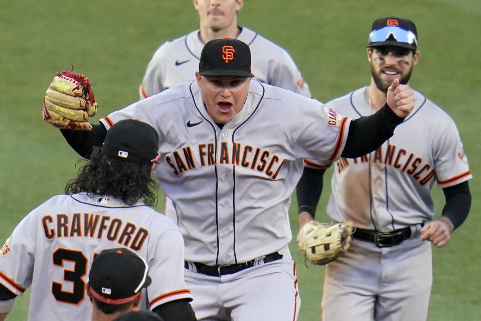 San Francisco Giants outfielder Joc Pederson, center, celebrates as he walks off the field after a baseball game against the Pittsburgh Pirates in Pittsburgh, Saturday, June 18, 2022. (AP Photo/Gene J. Puskar)