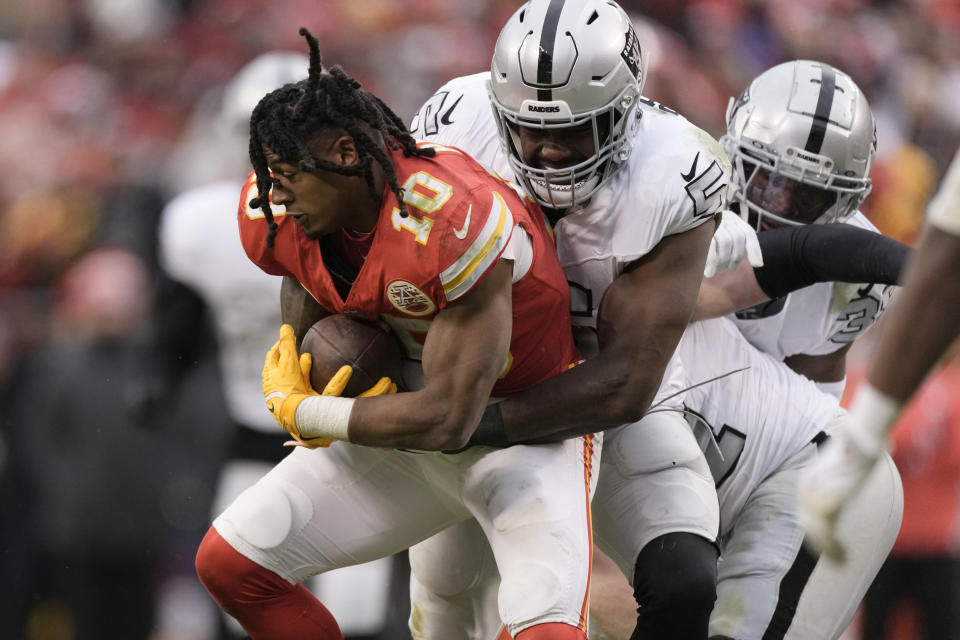 Kansas City Chiefs running back Isiah Pacheco (10) is stopped by Las Vegas Raiders linebacker Divine Deablo after Pacheco lost his helmet during a run during the second half of an NFL football game Monday, Dec. 25, 2023, in Kansas City, Mo. (AP Photo/Charlie Riedel)