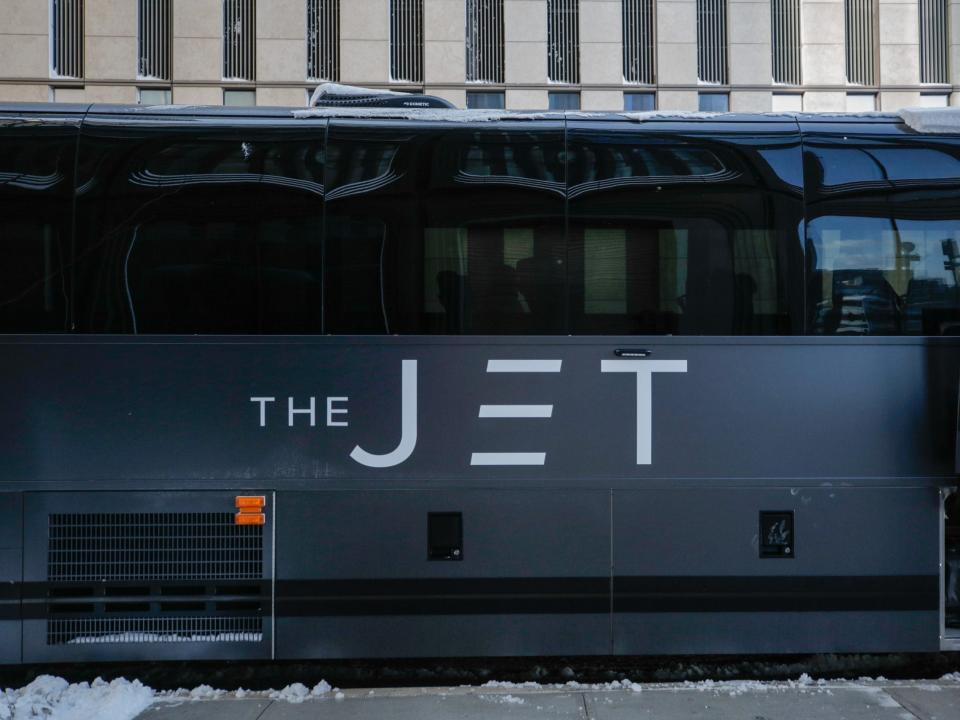 A matte black bus that reads "The Jet" on the side.