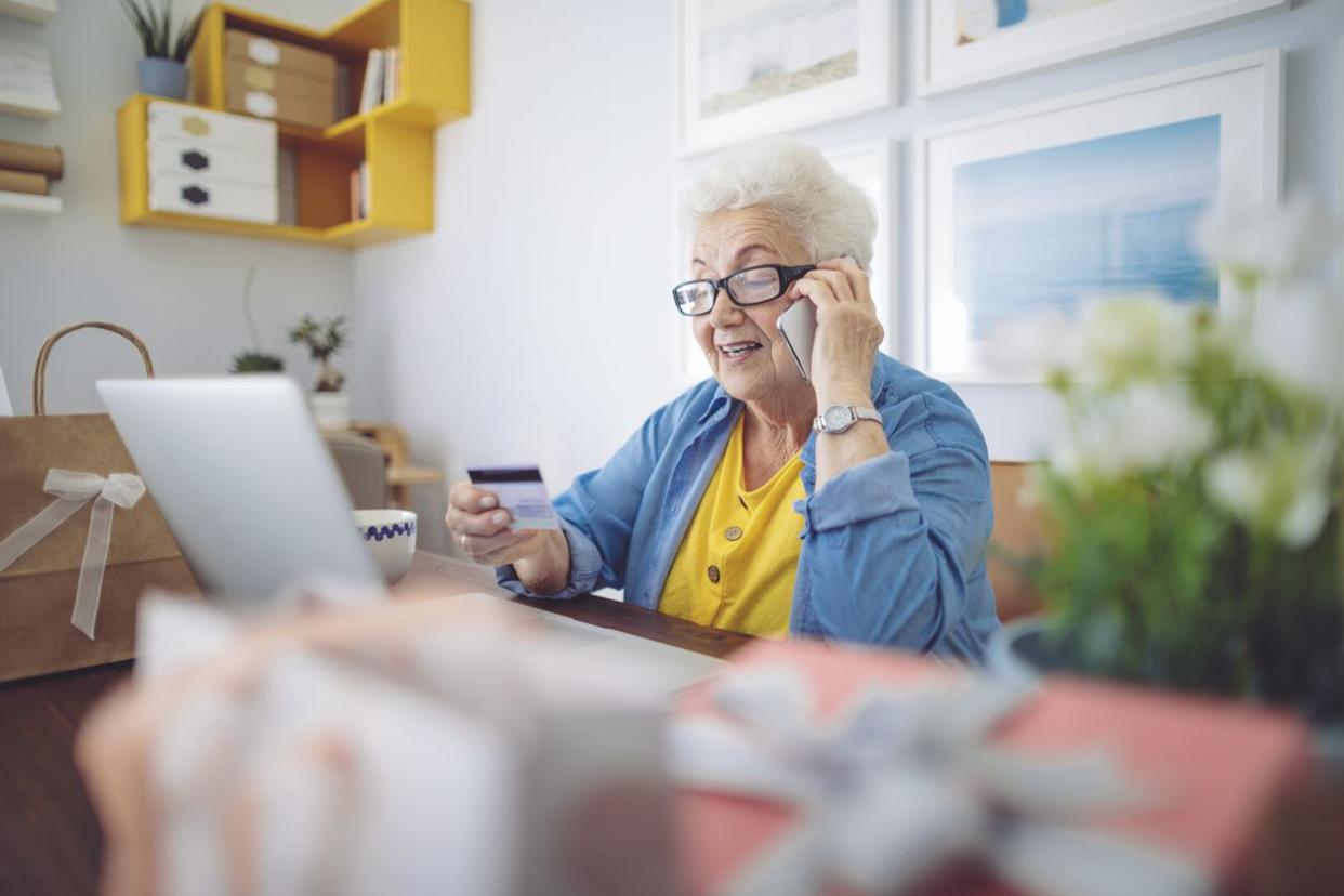 senior woman credit card phone