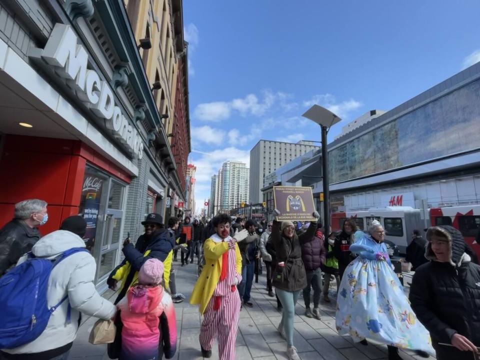 Hundreds of people marched from Confederation Park to 99 Rideau St. on March 19, 2023, to bid farewell to the McDonald's restaurant that has stood there since 1985.  (Avanthika Anand/CBC - image credit)