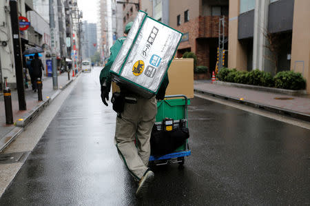 A deliverer of Yamato Transport Co is seen at a business district in Tokyo, Japan, February 9, 2017. REUTERS/Toru Hanai