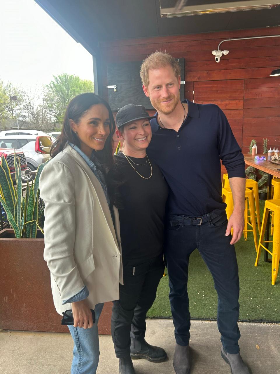 Prince Harry and Meghan visit La Barbecue in Austin and pose for a photo with owner Ali Clem.