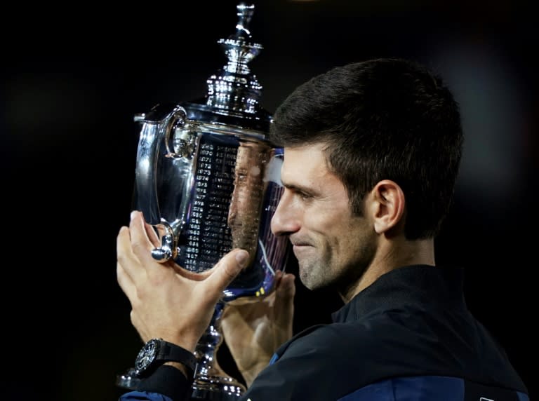 Champion: Novak Djokovic holds the trophy