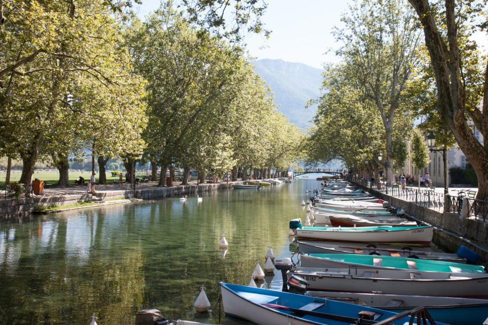 a scenic view of a row of boats by pont des amours in annecy, haute savoie, france