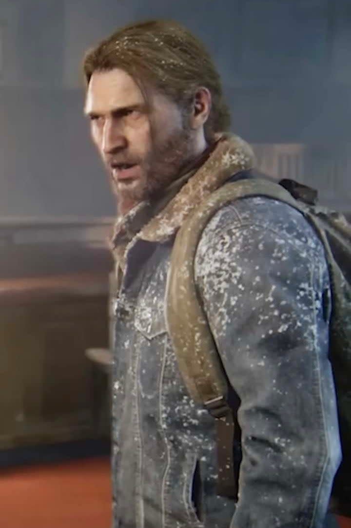 Tommy from The Last of Us Part II in a snowy environment, wearing a jacket and backpack, with a concerned expression