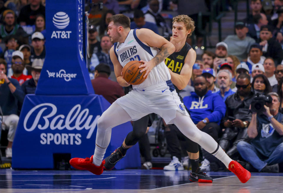 Dallas Mavericks point guard Luka Doncic. (77) looks to the hoop as Utah Jazz forward Lauri Markkanen, right, defends during the first half of an NBA basketball game, Wednesday, Nov. 2, 2022, in Dallas. (AP Photo/Gareth Patterson)