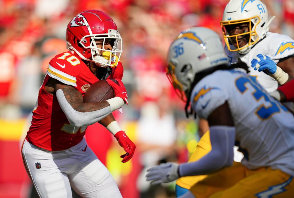 Oct 22, 2023; Kansas City, Missouri, USA; Kansas City Chiefs running back Isiah Pacheco (10) runs the ball against Los Angeles Chargers cornerback Ja'Sir Taylor (36) and defensive tackle Sebastian Joseph-Day (51) during the first half at GEHA Field at Arrowhead Stadium. Mandatory Credit: Jay Biggerstaff-USA TODAY Sports