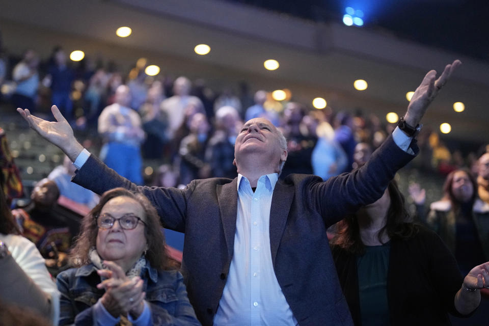 The faithful sing during a service at Lakewood Church, Sunday, Feb. 18, 2024, in Houston. Pastor Joel Osteen welcomed worshippers back to Lakewood Church Sunday for the first time since a woman with an AR-style opened fire in between services at his Texas megachurch last Sunday. (AP Photo/David J. Phillip)