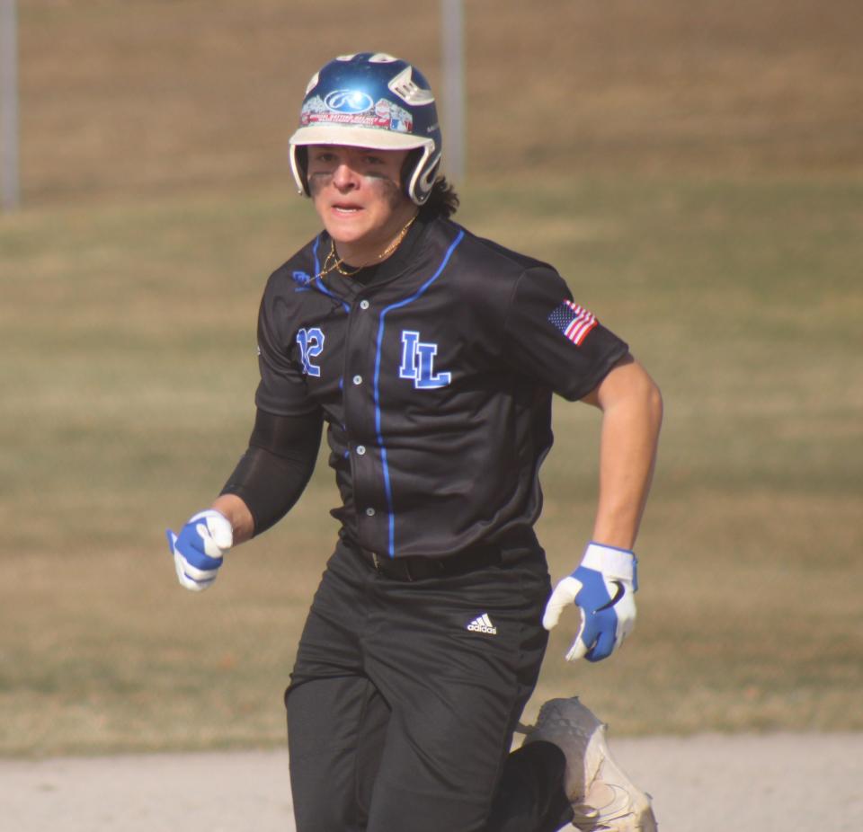 Inland Lakes junior Payton Teuthorn heads for third base during game one against Onaway on Tuesday.