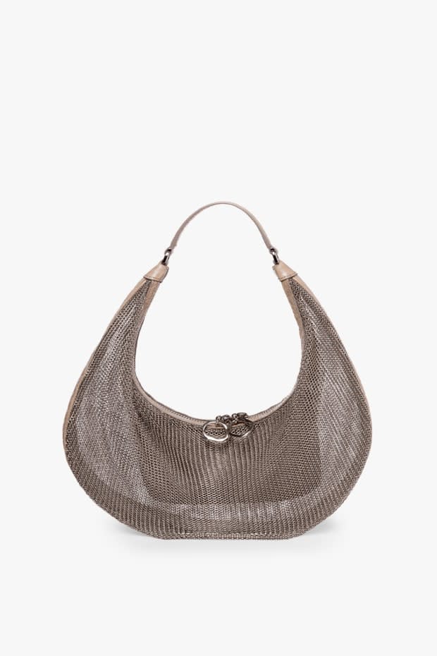 <p>Staud Sasha Bag, $450, <a href="https://staud.clothing/products/sasha-bag-ring-chainmail?variant=38085964595373&currency=USD&utm_medium=product_sync&utm_source=google&utm_content=sag_organic&utm_campaign=sag_organic&campaignid=12471902384&gclid=CjwKCAjwsNiIBhBdEiwAJK4khl4YNRXJuYvuiXa3zgRRynthy8AI6fW49Om8zZ_nN7N_oetlB0IjWhoCG2MQAvD_BwE" rel="nofollow noopener" target="_blank" data-ylk="slk:available here;elm:context_link;itc:0;sec:content-canvas" class="link ">available here</a>. </p>