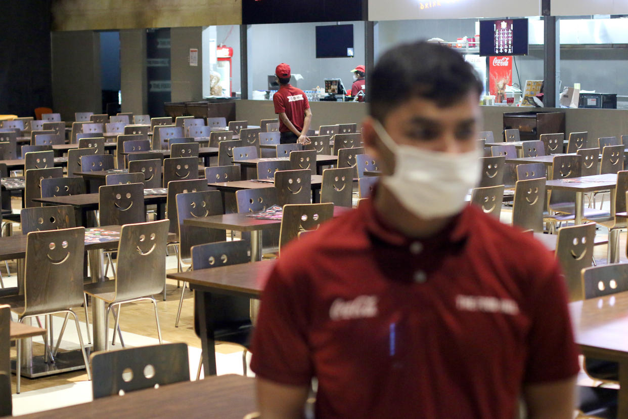 DHAKA, BANGLADESH - 2020/03/23: A  restaurant worker wears a face mask as a preventive measure against the spread of COVID-19 Coronavirus at an empty restaurant in Dhaka. Bangladesh has reported its third death from Covid-19, a new strain of coronavirus, infection. Six new Covid-19 patients were confirmed by Institute of Epidemiology, Disease Control and Research (IEDCR). As of now, a total of 33 cases have been confirmed. (Photo by Sultan Mahmud Mukut/SOPA Images/LightRocket via Getty Images)