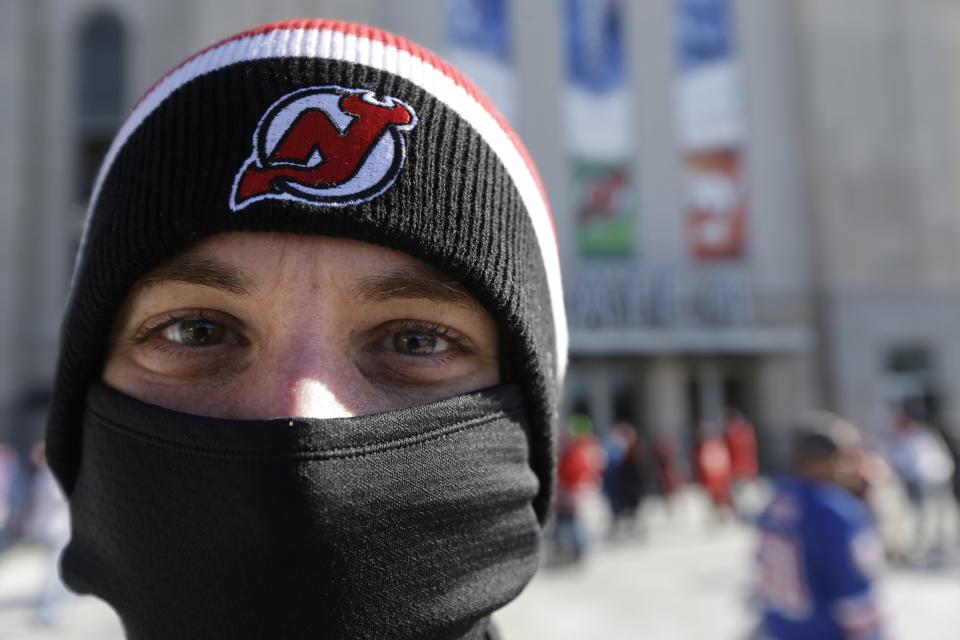 A New Jersey Devils fan arrives bundled up for an outdoor NHL hockey game between the New Jersey Devils and the New York Rangers Sunday, Jan. 26, 2014, at Yankee Stadium in New York. (AP Photo/Frank Franklin II)