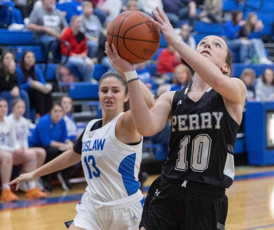 Perry's Marlee Pieru looks to shoot trailed by Tulsaw's Cici Huffman in the first half of Wednesday's game.