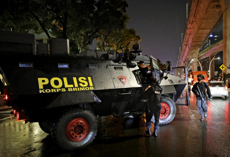 A police armored vehicle is parked outside the National Police Headquarters following a suspected militant attack in Jakarta, Indonesia, Wednesday, March 31, 2021. A woman entered the Indonesian National Police Headquarters in Jakarta and pointed a gun at several officers before being shot dead by police, in the latest in a series of suspected militant attacks in the world's most populous Muslim nation. (AP Photo/Dita Alangkara)